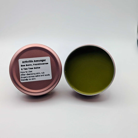 Open tin of Arthritis Assuenger Balm with label on a white background