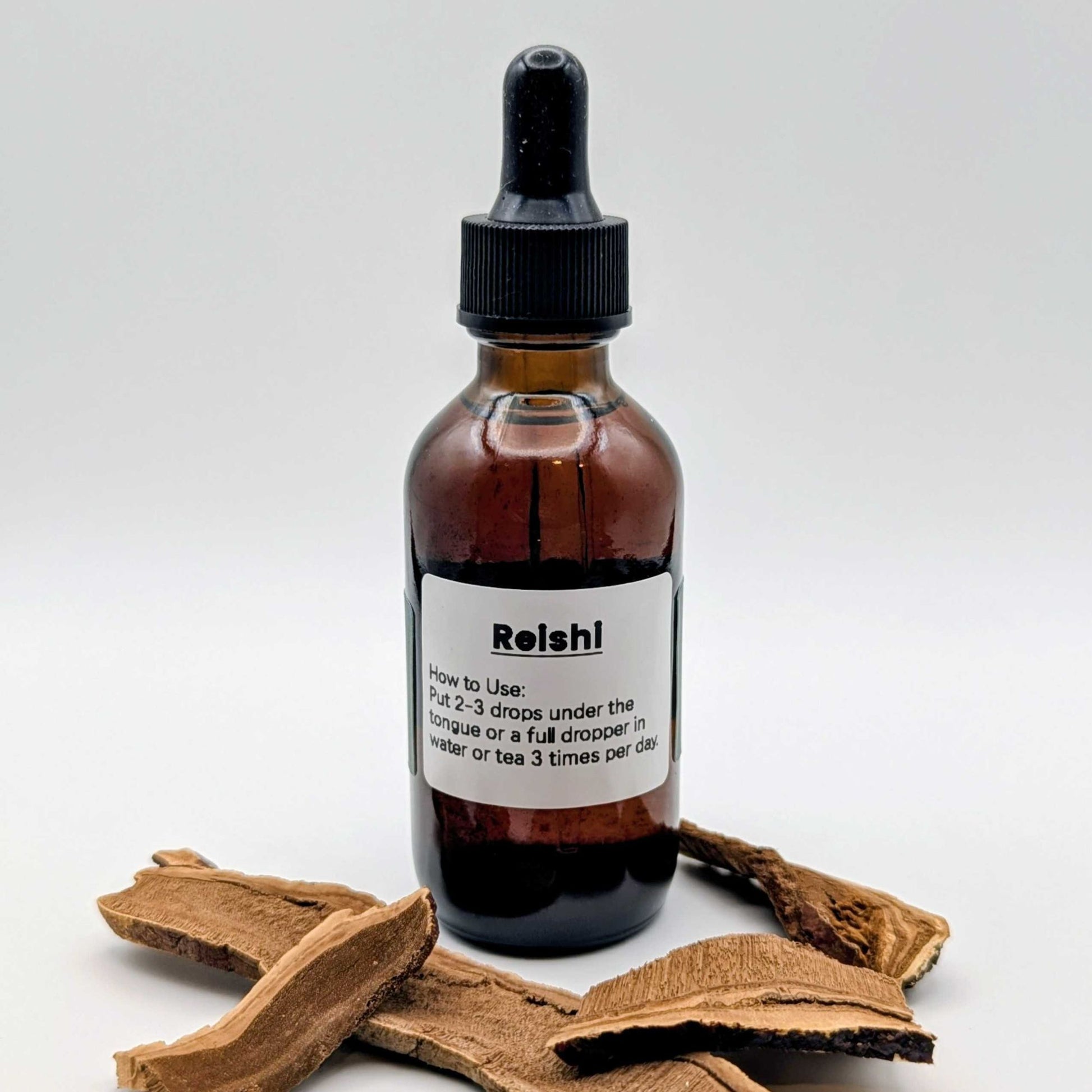 Bottle of Reishi liquid supplement with a wooden root on a white background