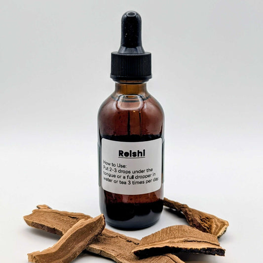 Bottle of Reishi liquid supplement with a wooden root on a white background
