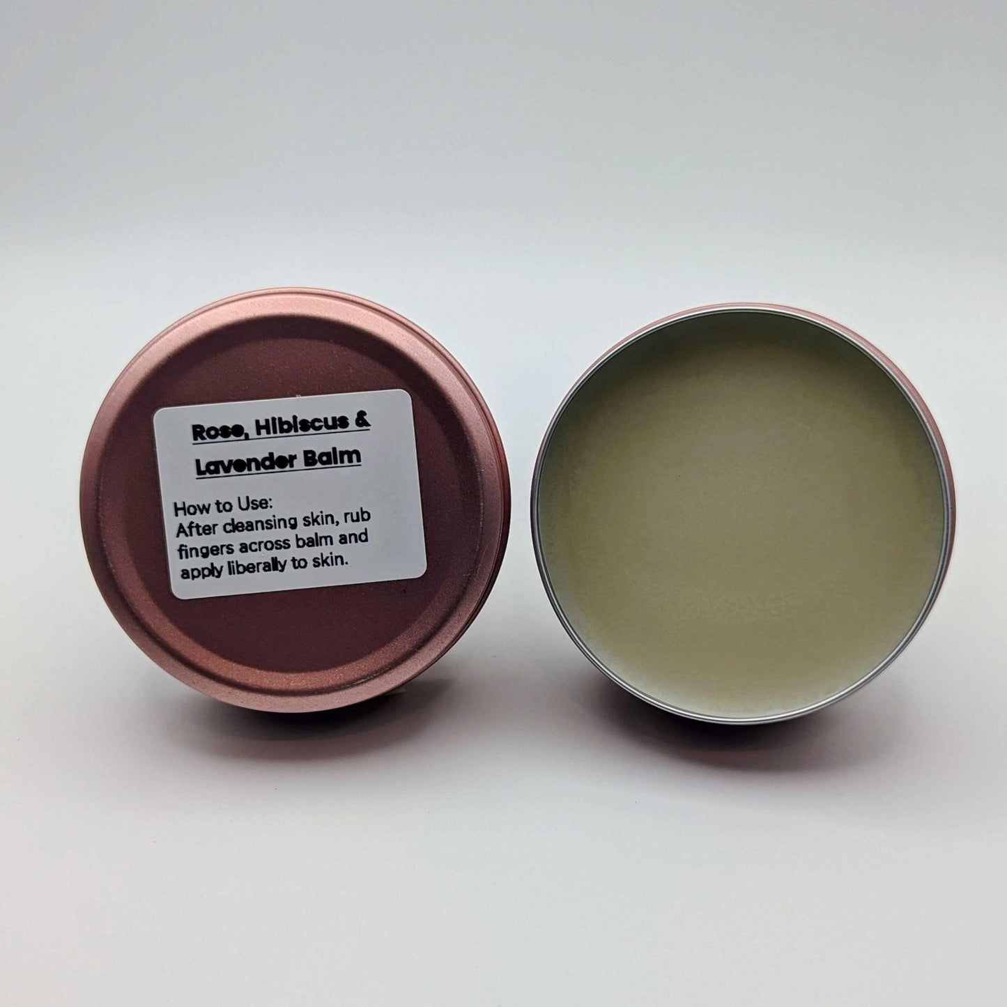 Rose, Hibiscus & Lavender Balm in a metal tin with lid open on a white background